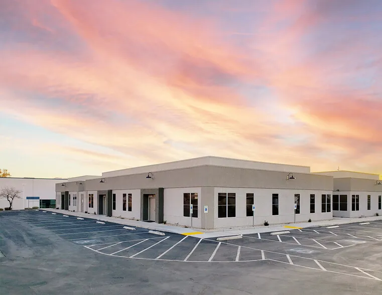 Tech Center Ct. office building under a sunset, a glowing pink sky